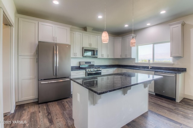 kitchen featuring a center island, dark wood-type flooring, recessed lighting, stainless steel appliances, and a sink