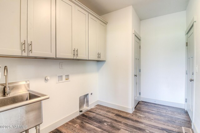 washroom with hookup for a washing machine, wood finished floors, cabinet space, electric dryer hookup, and a sink