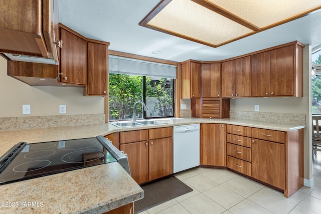5504 Webster Ave, Yakima, WA 98908 - kitchen featuring white dishwasher, electric stove, range hood, light countertops, and light tile patterned floors