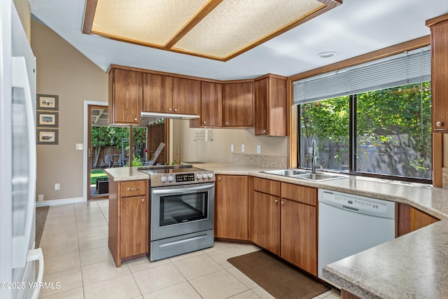 5504 Webster Ave, Yakima, WA 98908 - kitchen featuring white appliances, under cabinet range hood, light tile patterned floors, light countertops, and vaulted ceiling