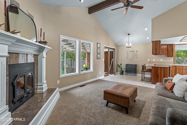 5504 Webster Ave, Yakima, WA 98908 - living area featuring high vaulted ceiling, beamed ceiling, ceiling fan, a tiled fireplace, and light tile patterned floors