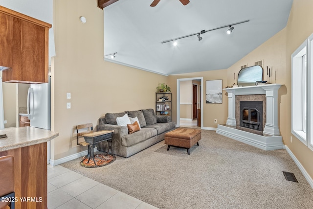 5504 Webster Ave, Yakima, WA 98908 - living room with rail lighting, vaulted ceiling, ceiling fan, a fireplace, and light tile patterned flooring