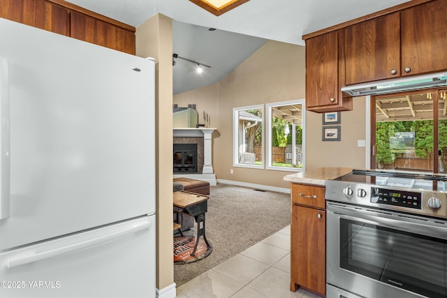5504 Webster Ave, Yakima, WA 98908 - kitchen with freestanding refrigerator, electric stove, vaulted ceiling, open floor plan, and light tile patterned floors