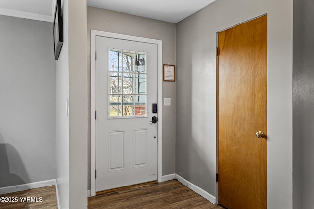 doorway to outside with baseboards and dark wood finished floors