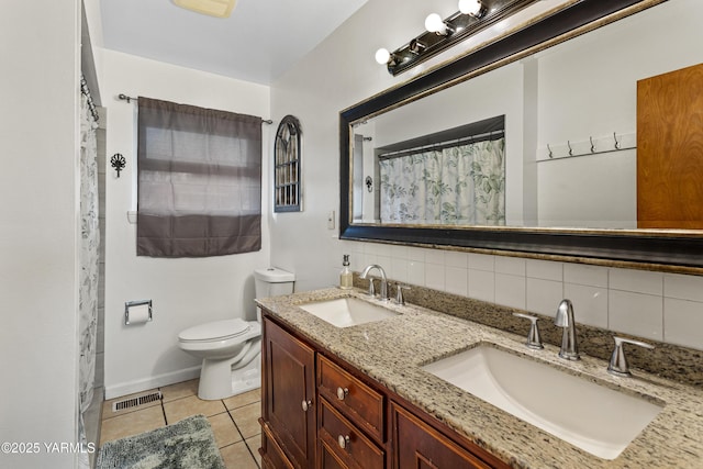 bathroom with toilet, visible vents, backsplash, and a sink