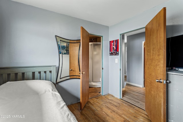 bedroom featuring baseboards and wood finished floors