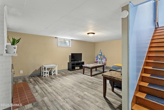game room with baseboards and wood finished floors