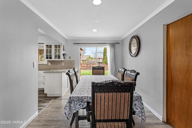 dining area with light wood-type flooring, recessed lighting, baseboards, and ornamental molding