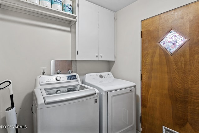 clothes washing area with washer and dryer, cabinet space, and visible vents