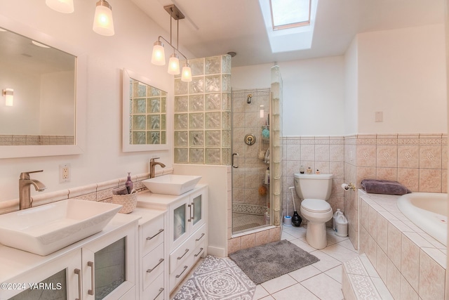 bathroom featuring a bath, tile patterned flooring, double vanity, and a sink