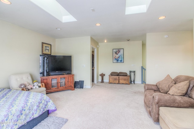 living area featuring a skylight, carpet, baseboards, and recessed lighting