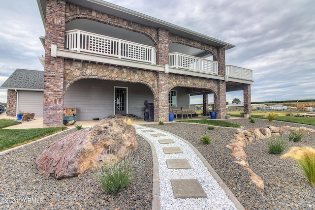 view of front facade featuring a patio area and a balcony