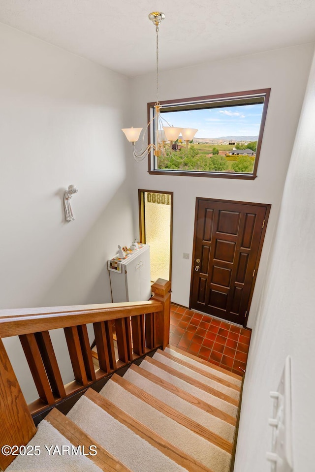 10800 Zier Rd, Yakima, WA 98908 - foyer featuring a chandelier, plenty of natural light, tile patterned flooring, and stairway