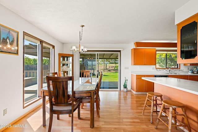 10800 Zier Rd, Yakima, WA 98908 - dining room featuring light wood-style flooring, a chandelier, and baseboards