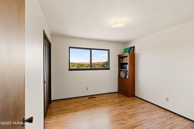 10800 Zier Rd, Yakima, WA 98908 - unfurnished bedroom featuring light wood-style flooring, a closet, and baseboards