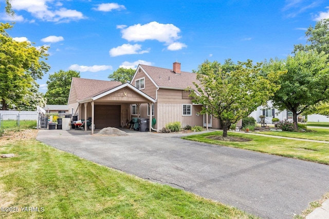 101 N 56th Ave, Yakima, WA 98908 - view of front of property featuring an attached garage, a chimney, driveway, and roof with shingles