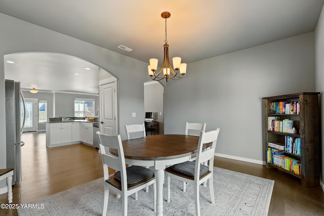 7402 Viewcrest Way, Yakima, WA 98908 - dining space featuring arched walkways, wood finished floors, and a chandelier