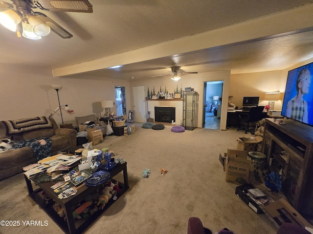 3204 W Viola Ave, Yakima, WA 98902 - living room with ceiling fan, carpet flooring, a fireplace, beamed ceiling, and an office area
