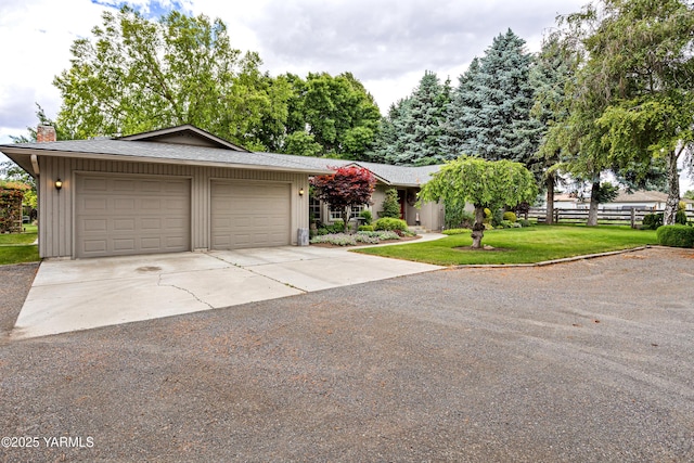 3012 S 79th Ave, Yakima, WA 98903 - view of front of house with a chimney, concrete driveway, an attached garage, and board and batten siding