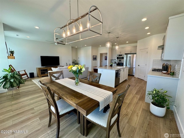 dining area featuring recessed lighting, light wood-style flooring, and baseboards