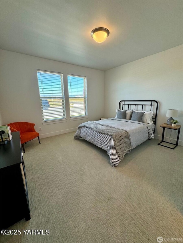 carpeted bedroom with baseboards