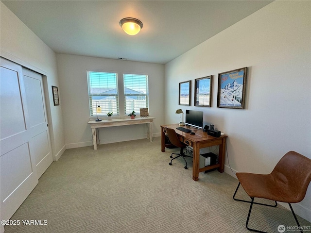 office space with baseboards and light colored carpet