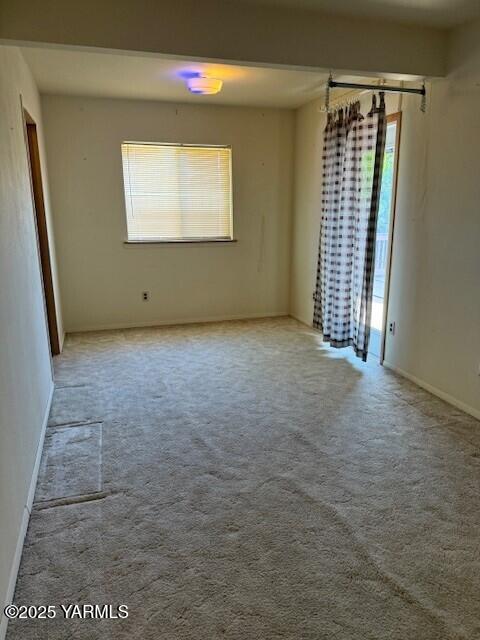 9 W Court St, Union Gap, WA 98903 - empty room with healthy amount of natural light and carpet floors