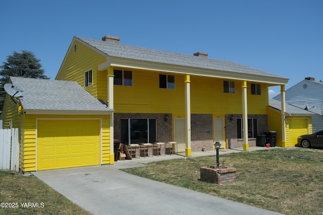 4013/4015 W Walnut St, Yakima, WA 98908 - view of front of home featuring an attached garage, brick siding, a chimney, and driveway