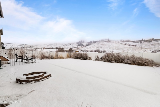 yard layered in snow with fence
