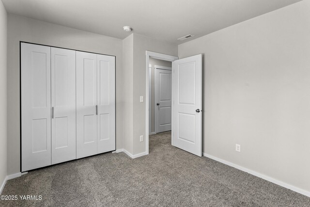 518 Chinook Winds Ln Lot 10, Tieton, WA 98947 - unfurnished bedroom with baseboards, a closet, visible vents, and carpet