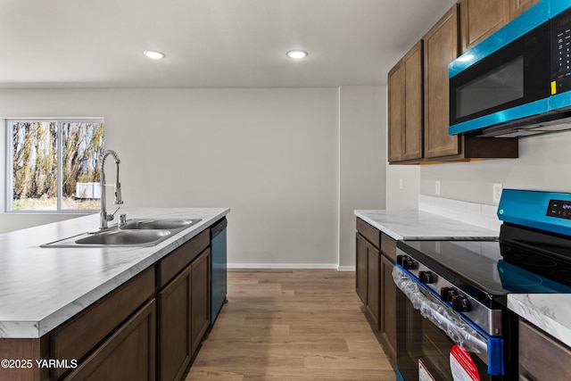 518 Chinook Winds Ln Lot 10, Tieton, WA 98947 - kitchen featuring light countertops, dishwasher, a sink, light wood-style floors, and stainless steel electric stove