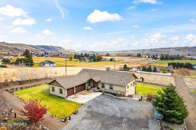 drone / aerial view with a mountain view and a rural view