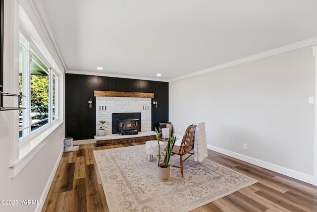 211 N 65th Pl, Yakima, WA 98908 - living room featuring ornamental molding, recessed lighting, wood finished floors, baseboards, and a wood stove