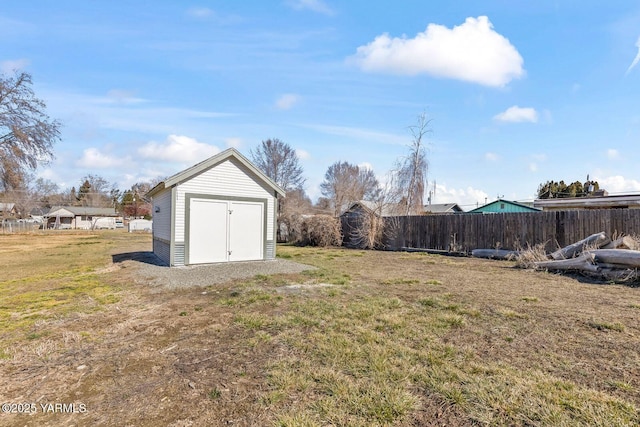 view of yard featuring an outbuilding, fence, and a storage shed