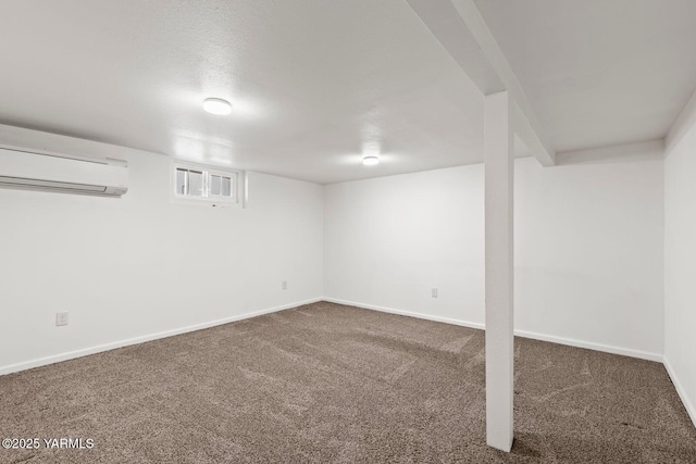 finished below grade area featuring carpet, an AC wall unit, and baseboards