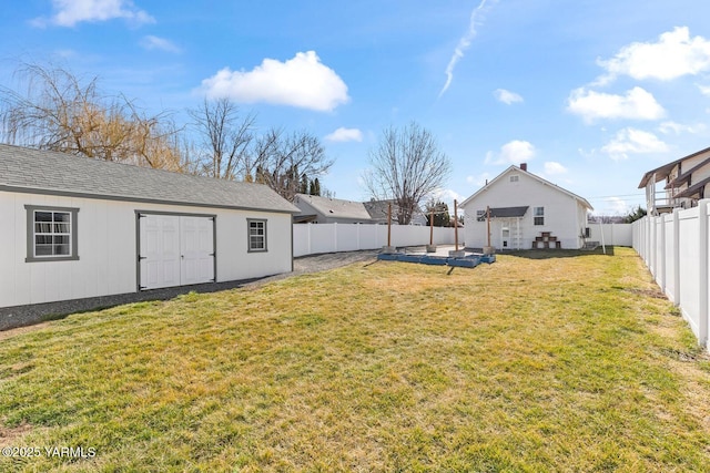 view of yard with an outdoor structure and a fenced backyard