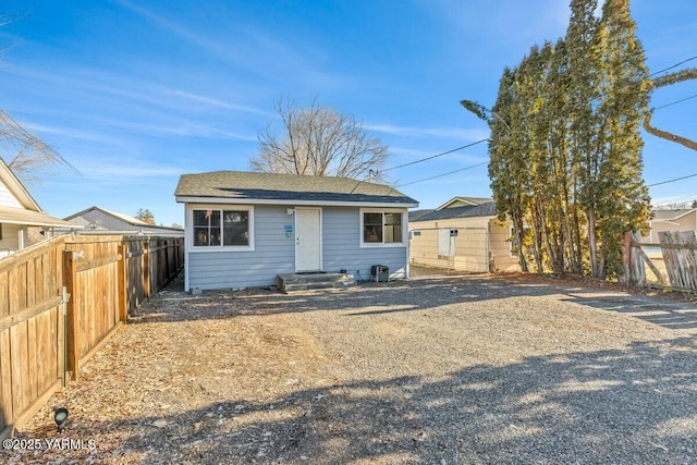 rear view of house featuring fence private yard