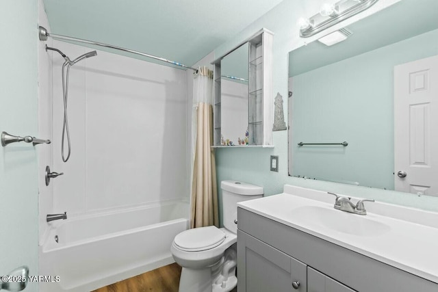 full bathroom with toilet, shower / bathtub combination with curtain, wood finished floors, and vanity