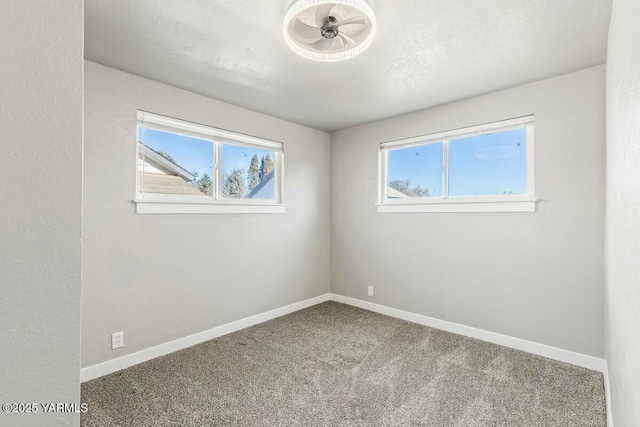 unfurnished room with carpet, plenty of natural light, and baseboards