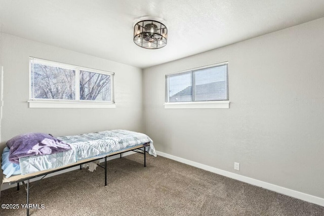 carpeted bedroom featuring baseboards