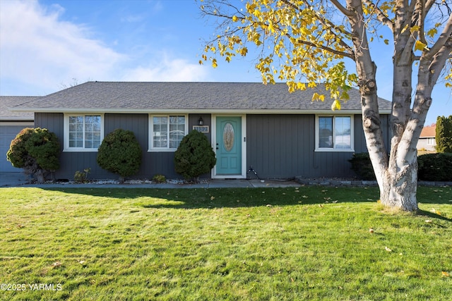 single story home featuring an attached garage, roof with shingles, and a front yard