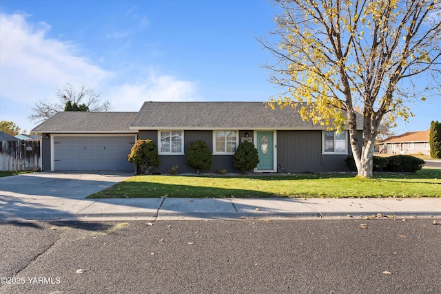 ranch-style house featuring a garage, concrete driveway, and a front yard