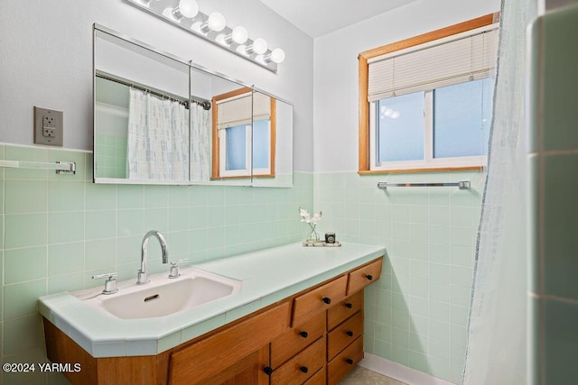 bathroom featuring tile walls and vanity