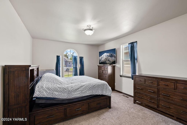 bedroom with light carpet, baseboards, and visible vents