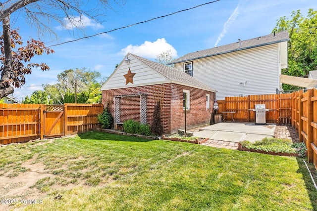 2102 Tieton Dr, Yakima, WA 98902 - rear view of house featuring a gate, a patio area, and brick siding