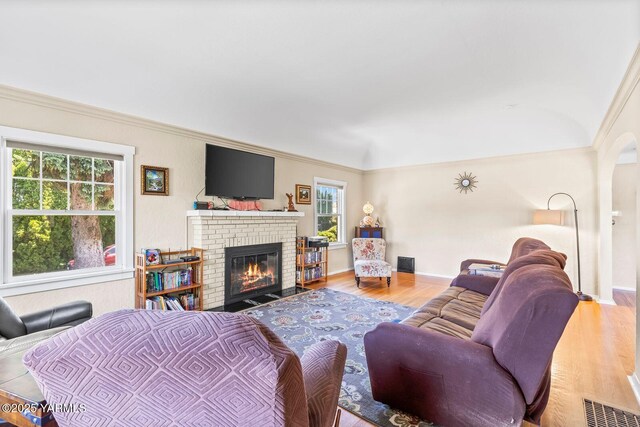 2102 Tieton Dr, Yakima, WA 98902 - living room with wood finished floors, plenty of natural light, a fireplace, ornamental molding, and baseboards