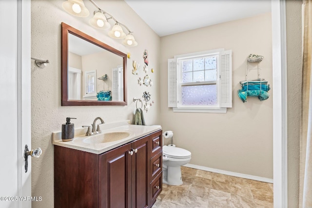 2102 Tieton Dr, Yakima, WA 98902 - bathroom featuring toilet, vanity, and baseboards