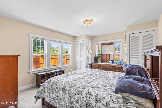 2102 Tieton Dr, Yakima, WA 98902 - bedroom with two closets, light carpet, and baseboards