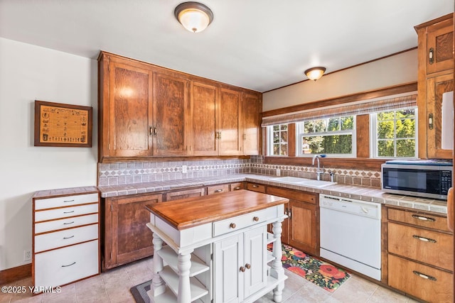 2102 Tieton Dr, Yakima, WA 98902 - kitchen with dishwasher, stainless steel microwave, a sink, open shelves, and tasteful backsplash