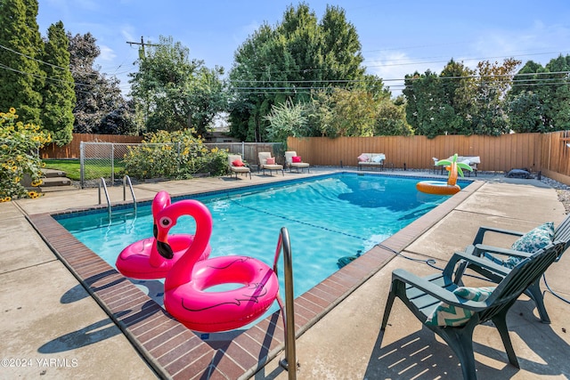 view of pool with a fenced backyard, a fenced in pool, and a patio